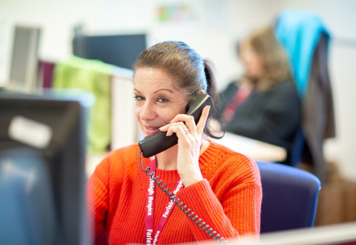 A woman answers the telephone