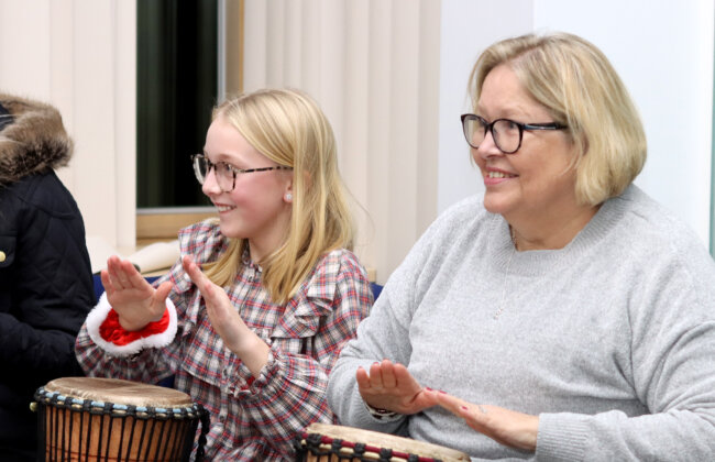 African drumming with a parent and child at the Yo Yo Christmas Party 2022