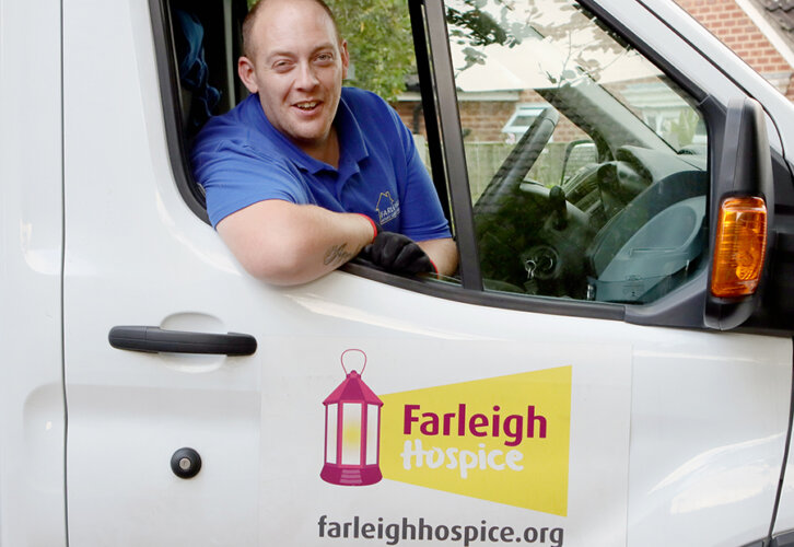 Billy, a member of the House Clearance team looks out of the driver side window of a van